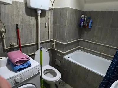 a bathroom with a toilet and a bath tub at Jednosoban stan centar Ela, in Pirot