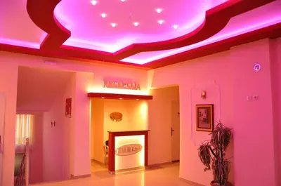 a room with a ceiling with a pink lighting at Rooms Turist in Vladičin Han