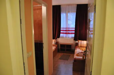 a hallway with a living room with a window at Rooms Turist in Vladičin Han