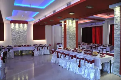 a banquet hall with white tables and chairs at Rooms Turist in Vladičin Han