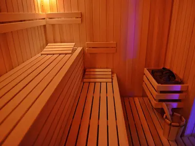a sauna with two beds and a bucket in it at Guesthouse Đokić in Leskovac