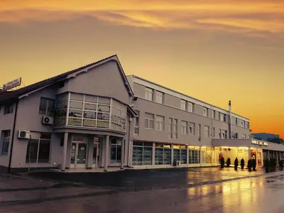 a large building with people standing outside of it at Guesthouse Đokić in Leskovac