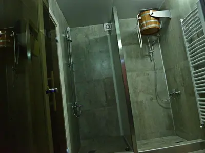a shower with a glass door in a bathroom at Guesthouse Đokić in Leskovac