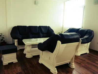 a living room with a couch and a table at Guesthouse Đokić in Leskovac