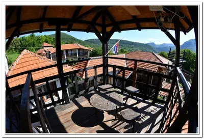 a large wooden deck with a view of a house at Golemi kamik Pirot Vlasi 4 in Pirot