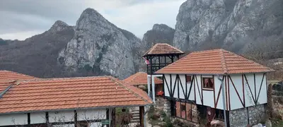 a group of buildings with mountains in the background at Golemi kamik Pirot Vlasi 4 in Pirot