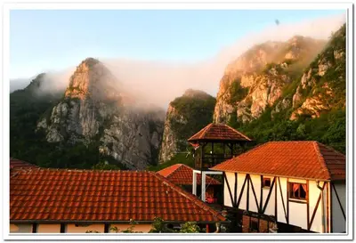 a view of a mountain with clouds and buildings at Golemi kamik Pirot Vlasi 4 in Pirot