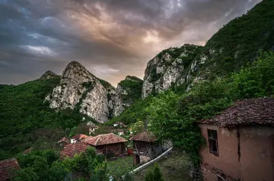 a village in the mountains under a cloudy sky at Golemi kamik Pirot Vlasi 2 in Pirot