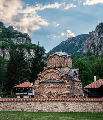 an old brick building with mountains in the background at Golemi kamik Pirot Vlasi 2 in Pirot