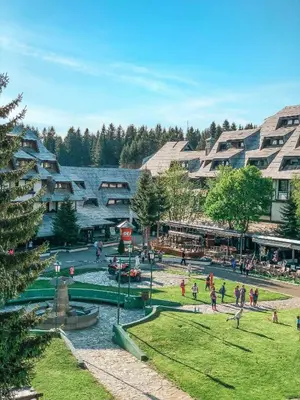 a group of people walking around a park at Apartments Suncani Vrhovi Kopaonik in Kopaonik