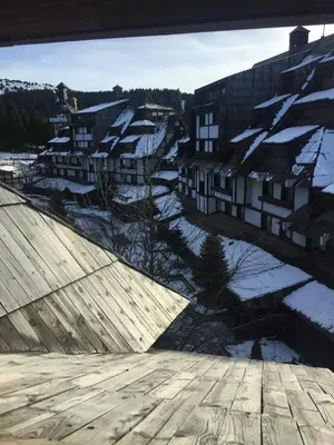 a view of a city with snow covered buildings at Apartments Suncani Vrhovi Kopaonik in Kopaonik
