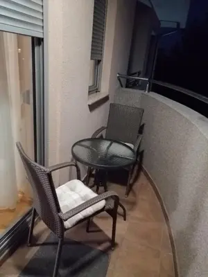 two chairs and a table on a balcony at Apartmani Kesten in Vrnjačka Banja