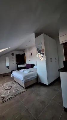a bedroom with a bed and a refrigerator at Kopaonik - Milmari resort S65 in Kopaonik