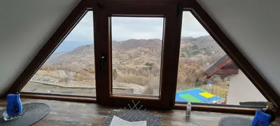 a large window with a view of a mountain at Kopaonik - Milmari resort S65 in Kopaonik