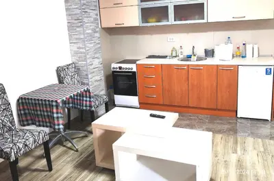 a kitchen with a sink and a stove top oven at Junona Magenta in Prokuplje