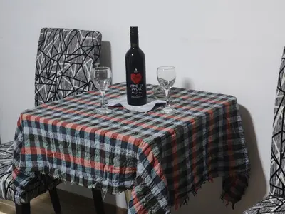 a bottle of wine sitting on a table with two glasses at Junona Magenta in Prokuplje