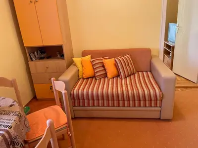a living room with a couch with colorful pillows at Just like home in Vrnjačka Banja