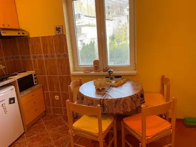 a kitchen with a table and two chairs and a sink at Just like home in Vrnjačka Banja