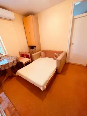 a small bedroom with a bed and a table at Just like home in Vrnjačka Banja