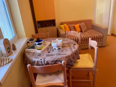 a living room with a table and a couch at Just like home in Vrnjačka Banja