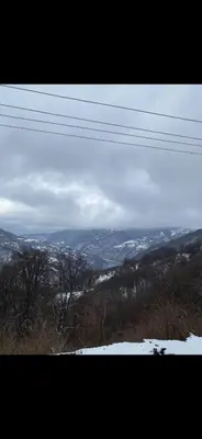 a view of a snow covered hill with power lines at ANN III in Vlasina Rid