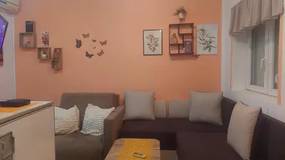 a living room with a couch and a window at Mrvica in Vrnjačka Banja