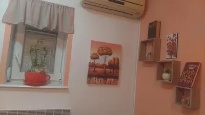 a window with a painting of trees on a wall at Mrvica in Vrnjačka Banja