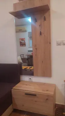 a mirror above a wooden dresser in a room at Mrvica in Vrnjačka Banja