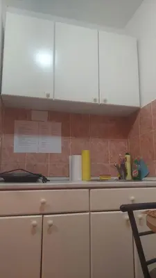 a kitchen with white cabinets and a counter top at Mrvica in Vrnjačka Banja