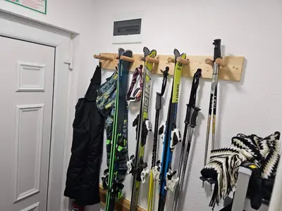 a bunch of skis are hanging on a wall at Apartman Čar11 in Kopaonik