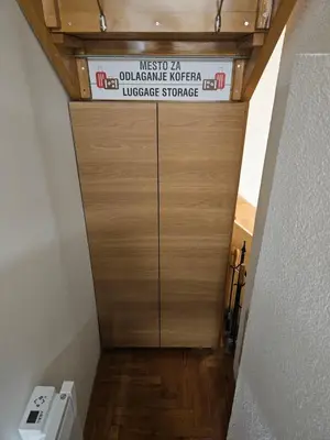a wooden door in a hallway with a sign on it at Apartman Čar11 in Kopaonik