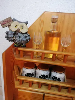 a wooden shelf with wine glasses and a vase at Etno-urban stan na dan in Paraćin
