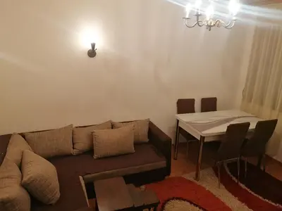 a living room with a couch and a table at Etno-urban stan na dan in Paraćin