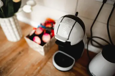 a black and white coffee maker next to a box of apples at Apartman VELUK in Vrnjci
