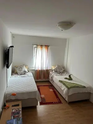 a bedroom with two beds and a window at Aparmani Ušće in Trstenik