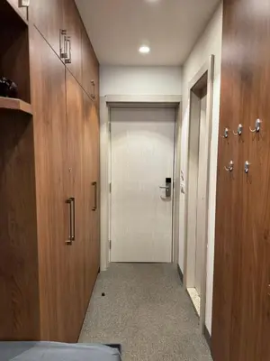 a hallway with a white door and wooden walls at Apartmani Kilijan Kopaonik in Kopaonik