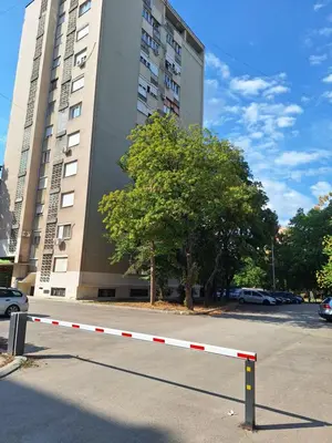 a white and red barrier in front of a building at Relax Lux apartment Nis in Niš