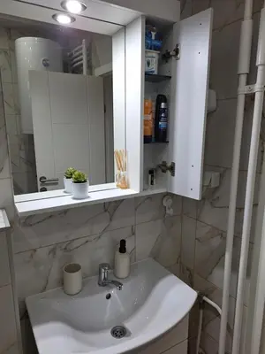 a bathroom with a sink and a mirror at Relax Lux apartment Nis in Niš