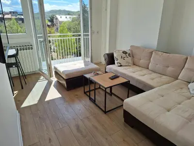 a living room with a couch and a table at Relax Lux apartment Nis in Niš
