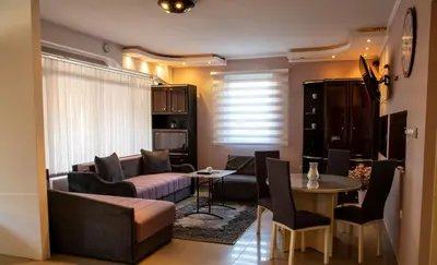 a living room with a couch and a table at Apartman Lara in Kuršumlija