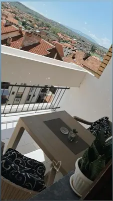 a table and chairs on a balcony with a view at Apartman MIKA in Zaječar