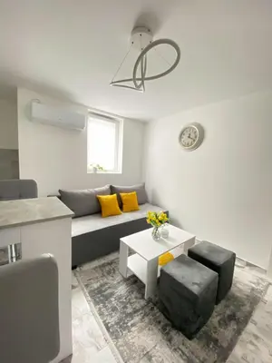 a living room with a couch and a table at Apartman Amaris in Vrnjačka Banja