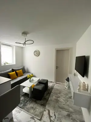a living room with a couch and a tv at Apartman Amaris in Vrnjačka Banja