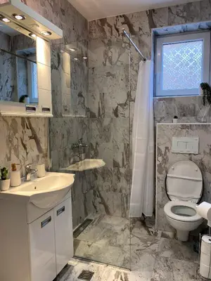 a bathroom with a toilet and a sink and a shower at Apartman Amaris in Vrnjačka Banja