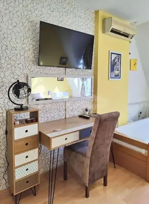a desk with a chair and a mirror in a bedroom at Yellow Diamond in Niš