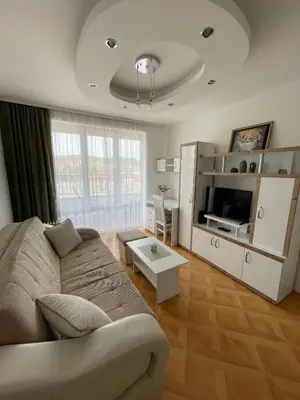 a living room with a couch and a tv at Apartman Dragovic in Kuršumlija