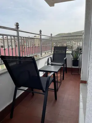 two chairs and a table on a balcony at Apartman Dragovic in Kuršumlija