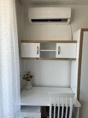 a room with white shelves and a white curtain at Apartman Dragovic in Kuršumlija