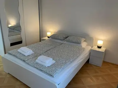 a bedroom with a bed with two towels on it at Apartman Dragovic in Kuršumlija