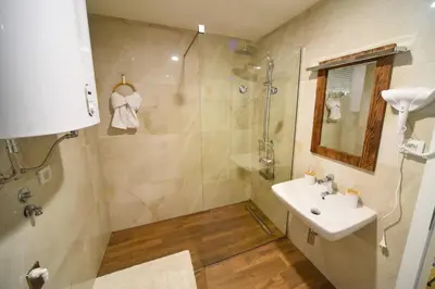 a bathroom with a sink and a shower at BAGDALA RESIDENCE APARTMAN in Kruševac